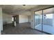 A large living room leads to the backyard through sliding glass doors at 15773 W Beryl Ave, Waddell, AZ 85355