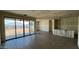 Spacious unfinished living room featuring stylish flooring, drywall walls, and sliding door access to the backyard at 15773 W Beryl Ave, Waddell, AZ 85355
