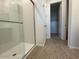 Walk in shower with seamless glass door, and tile floors with white trim accents at 15773 W Beryl Ave, Waddell, AZ 85355