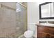 Bathroom featuring a tiled shower, neutral walls, and a vanity with granite countertop at 16421 N 65Th Pl, Scottsdale, AZ 85254