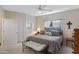 Bedroom with a ceiling fan, sitting bench, and double-door closet at 16450 E Ave Of The Fountains -- # 14, Fountain Hills, AZ 85268