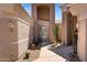 Close up of entrance, featuring desert landscaping, pavers, desert plants and an iron security screen door at 16450 E Ave Of The Fountains -- # 14, Fountain Hills, AZ 85268