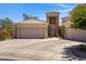 Home featuring a driveway leading to a three car garage, desert landscaping, and a covered front entrance at 16450 E Ave Of The Fountains -- # 14, Fountain Hills, AZ 85268