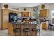 Kitchen featuring wood cabinets, tile flooring, black appliances and bar seating at 16450 E Ave Of The Fountains -- # 14, Fountain Hills, AZ 85268