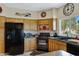 The eat-in kitchen is equipped with black appliances and light wood cabinets at 16450 E Ave Of The Fountains -- # 14, Fountain Hills, AZ 85268