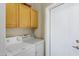 The laundry room has cabinets above the washer and dryer at 16450 E Ave Of The Fountains -- # 14, Fountain Hills, AZ 85268