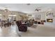 Spacious living room featuring neutral tones, a fireplace, ceiling fans, an eat-in kitchen and multiple sitting areas at 16450 E Ave Of The Fountains -- # 14, Fountain Hills, AZ 85268