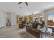 Open concept living room with an eat in kitchen area, ceiling fans and a sliding glass door at 16450 E Ave Of The Fountains -- # 14, Fountain Hills, AZ 85268