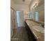 Bathroom featuring double sinks, a granite countertop, and wood-look floors at 1734 W Pollack St, Phoenix, AZ 85041