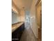 Bathroom featuring double sinks, a granite countertop, and wood-look floors at 1734 W Pollack St, Phoenix, AZ 85041