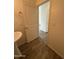 A half-bathroom features a bright, neutral color scheme with decorative lighting and tile flooring at 1734 W Pollack St, Phoenix, AZ 85041