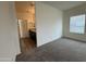 Spacious bedroom featuring neutral carpeting, a ceiling fan, and a pass-through to the bathroom at 1734 W Pollack St, Phoenix, AZ 85041