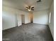 Spacious carpeted bedroom featuring a ceiling fan and neutral paint at 1734 W Pollack St, Phoenix, AZ 85041