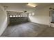 Spacious two-car garage with finished concrete floors, an automatic door opener, and a large water heater at 1734 W Pollack St, Phoenix, AZ 85041