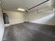 Spacious two-car garage with finished concrete floors, an automatic door opener, and a large water heater at 1734 W Pollack St, Phoenix, AZ 85041