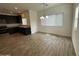 Open concept kitchen with black cabinets, stainless steel appliances, and adjacent dining area at 1734 W Pollack St, Phoenix, AZ 85041