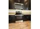 Close-up of kitchen appliances, including a stainless steel oven and microwave, set against dark cabinetry at 1734 W Pollack St, Phoenix, AZ 85041