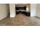 Spacious open-concept home with black cabinets, stainless appliances, and wood-style flooring at 1734 W Pollack St, Phoenix, AZ 85041