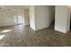 Bright living room with wood-look flooring and large windows, staircase to the side at 1734 W Pollack St, Phoenix, AZ 85041