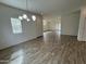 Open concept living and dining areas with wood-look flooring and modern chandelier at 1734 W Pollack St, Phoenix, AZ 85041
