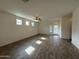 Open living area featuring wood-look flooring, lots of natural light, and modern ceiling fan at 1734 W Pollack St, Phoenix, AZ 85041