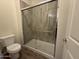 Bathroom featuring a tiled shower with a glass door and modern fixtures at 1734 W Pollack St, Phoenix, AZ 85041