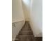 Interior view of a carpeted staircase leading to a higher level with white walls and a handrail at 1734 W Pollack St, Phoenix, AZ 85041