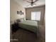 Neutral bedroom with a ceiling fan and window at 17447 W Yavapai St, Goodyear, AZ 85338