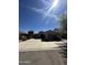 Single-story home with arched entryway, well-maintained landscaping, and concrete driveway at 17447 W Yavapai St, Goodyear, AZ 85338