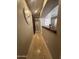 Hallway with tiled floors, archways, and a large decorative wall clock at 17447 W Yavapai St, Goodyear, AZ 85338