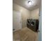 Laundry room with modern washer and dryer units and tiled floor at 17447 W Yavapai St, Goodyear, AZ 85338