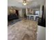 Open-concept living room with travertine floors, ceiling fans, and neutral decor at 17447 W Yavapai St, Goodyear, AZ 85338