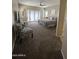 Spacious main bedroom featuring carpeted floors, a ceiling fan, and patio access at 17447 W Yavapai St, Goodyear, AZ 85338