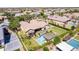 Gorgeous aerial view of a home featuring a sparkling pool, pergola, manicured lawn, and verdant landscaping at 17673 E Bronco Dr, Queen Creek, AZ 85142