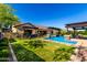 Backyard oasis with pool, pergola, and lush landscaping, perfect for relaxation at 17673 E Bronco Dr, Queen Creek, AZ 85142