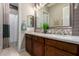 Bathroom featuring dark wood cabinets, double sinks and modern fixtures at 17673 E Bronco Dr, Queen Creek, AZ 85142