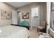 Bedroom featuring a gray and white patterned bedspread and colorful decor at 17673 E Bronco Dr, Queen Creek, AZ 85142