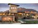 Elegant community entrance featuring stone architecture and mountain views at 17673 E Bronco Dr, Queen Creek, AZ 85142
