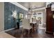 Elegant dining room with herringbone wallpaper, wood floors, and decorative lighting at 17673 E Bronco Dr, Queen Creek, AZ 85142