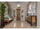 Elegant foyer with travertine floors, decorative light fixture, and stylish console table at 17673 E Bronco Dr, Queen Creek, AZ 85142