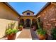 Inviting front entrance with brick pathway and potted plants leading to a charming home at 17673 E Bronco Dr, Queen Creek, AZ 85142