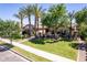Well-maintained lawn and mature trees in the front yard of a gorgeous single story home at 17673 E Bronco Dr, Queen Creek, AZ 85142