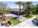 Lovely home featuring an attached three car garage, manicured front yard, and palm trees at 17673 E Bronco Dr, Queen Creek, AZ 85142