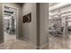Bright hallway showcasing elegant flooring and connecting to the living spaces at 17673 E Bronco Dr, Queen Creek, AZ 85142