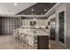 The large kitchen island is the focal point, featuring stone accents, seating for four and modern appliances at 17673 E Bronco Dr, Queen Creek, AZ 85142