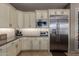 A kitchen highlighting stainless steel appliances and cream colored cabinets with modern hardware and design at 17673 E Bronco Dr, Queen Creek, AZ 85142