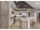 Bright kitchen boasts modern appliances, ample counter space, stone accent bar and stylish pendant lighting at 17673 E Bronco Dr, Queen Creek, AZ 85142