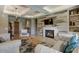 Open living room featuring a fireplace with decorative tilework, recessed lighting, and stylish furniture at 17673 E Bronco Dr, Queen Creek, AZ 85142