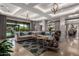 Spacious living room featuring coffered ceilings, travertine floors, and a seamless indoor-outdoor flow at 17673 E Bronco Dr, Queen Creek, AZ 85142
