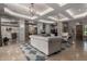 Spacious living room with travertine floors, stylish decor and access to other rooms at 17673 E Bronco Dr, Queen Creek, AZ 85142